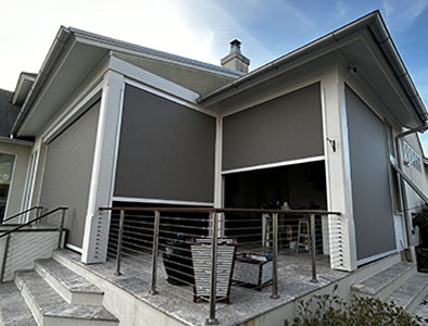 Motion screens creating a shaded patio lounge area for outdoor relaxation in Lafayette, LA