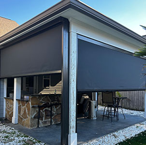Pergola motion screens installed on a backyard patio for shade and privacy in Lafayette, Louisiana