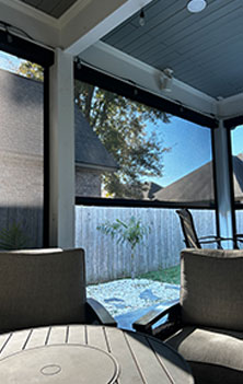 Motion screens enclosing an outdoor living space to improve comfort and insect protection in Lafayette, LA