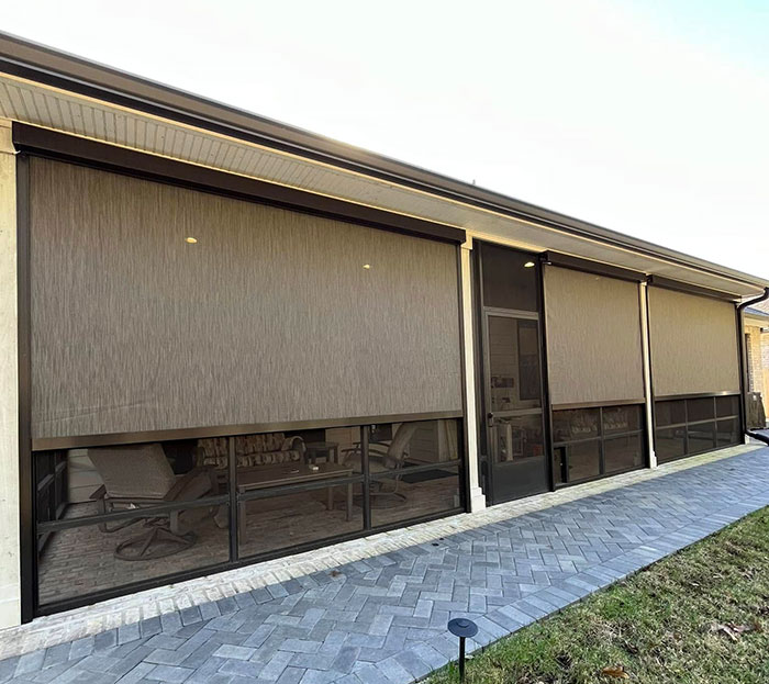 Full-length motion screens enclosing a patio area for shade and insect control in Lafayette, LA