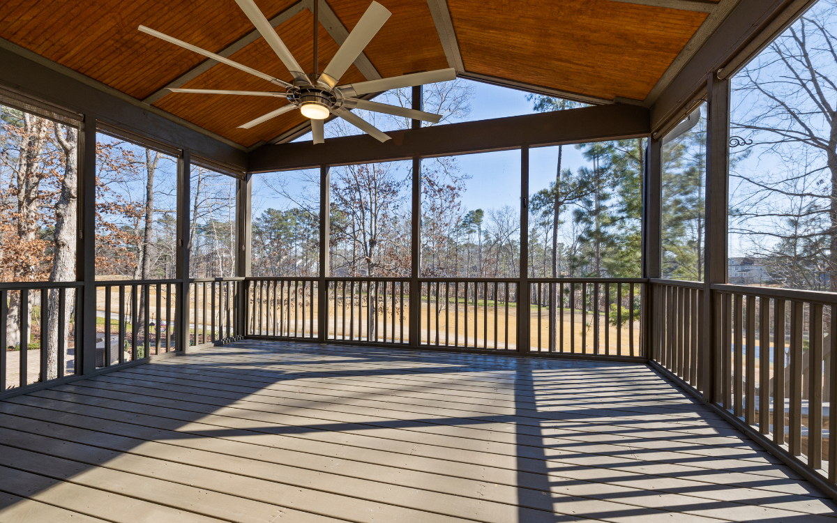 Pergola motion screens enclosing a wooden deck for shade and airflow in Lafayette, Louisiana