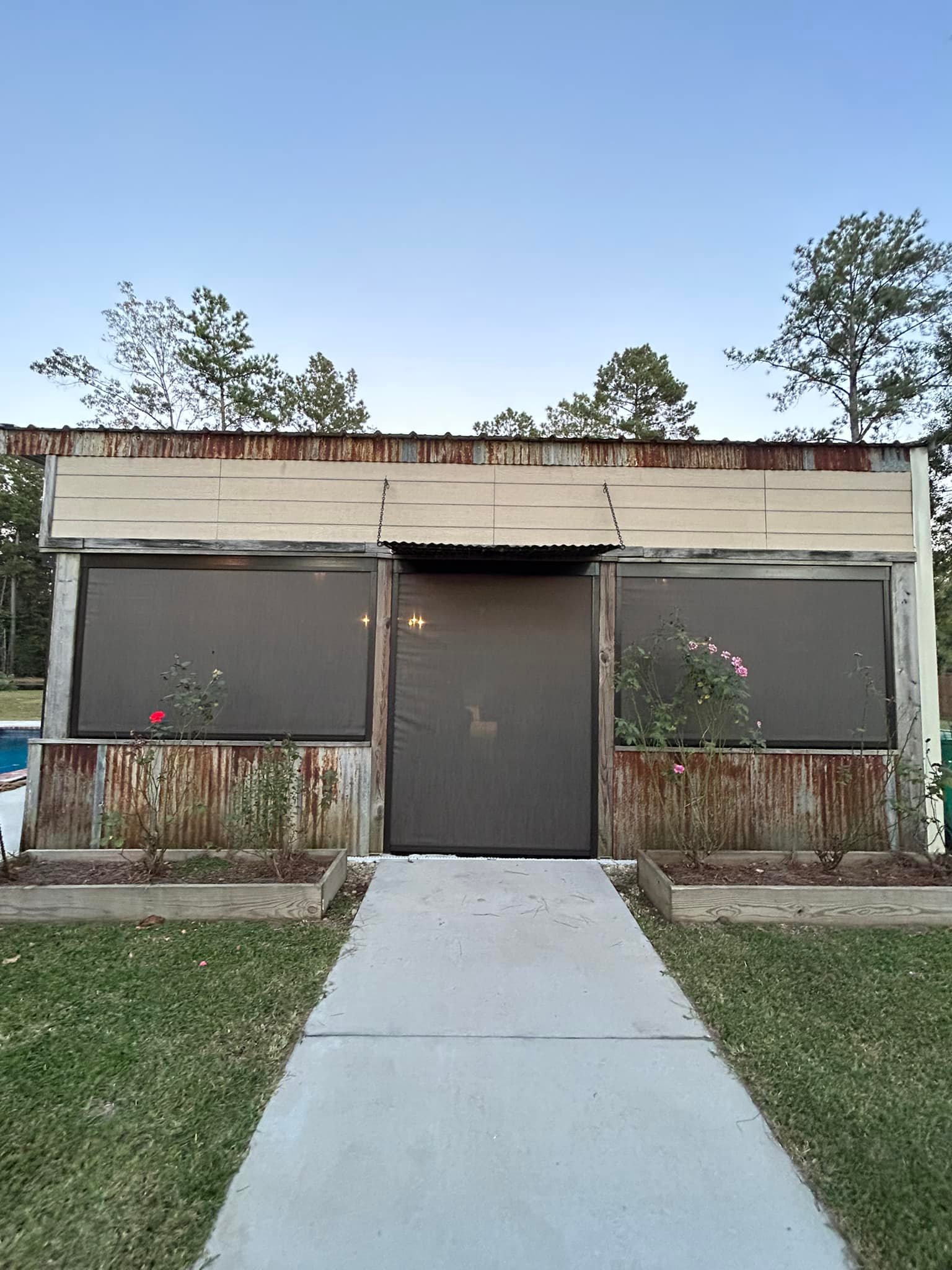 Motion screens installed on a detached garage for shade and insect protection in Lafayette, LA