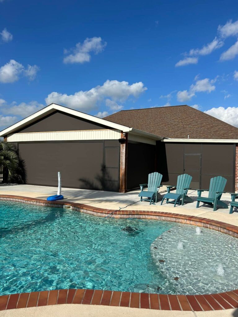 Motion screens installed near a backyard pool for shade and outdoor comfort in Lafayette, Louisiana