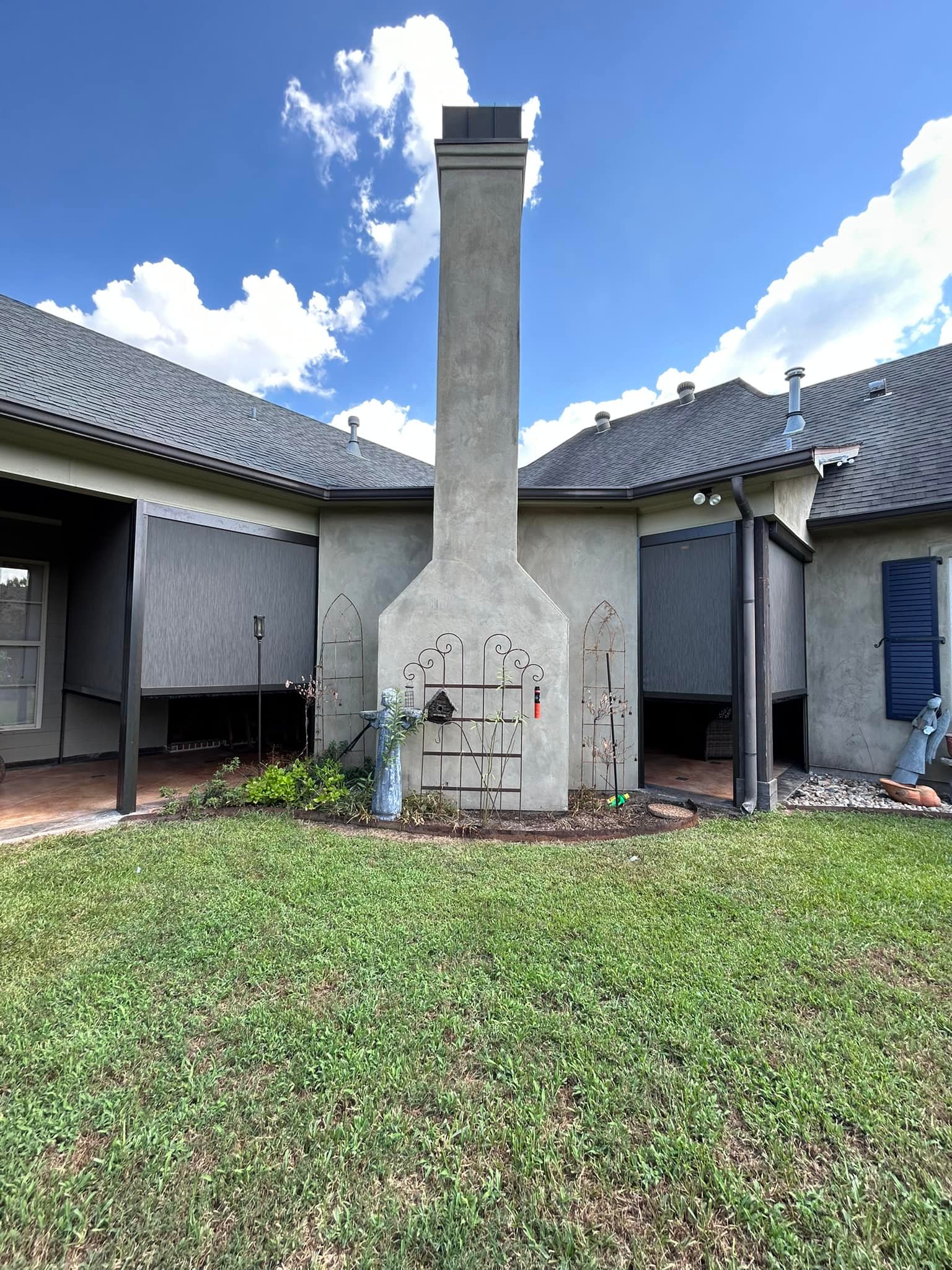 Garage motion screens providing shade and privacy for an outdoor structure in Lafayette, Louisiana