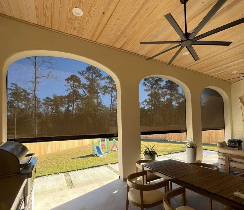 Motion screens installed on an arched patio opening for shade and privacy in Lafayette, LA