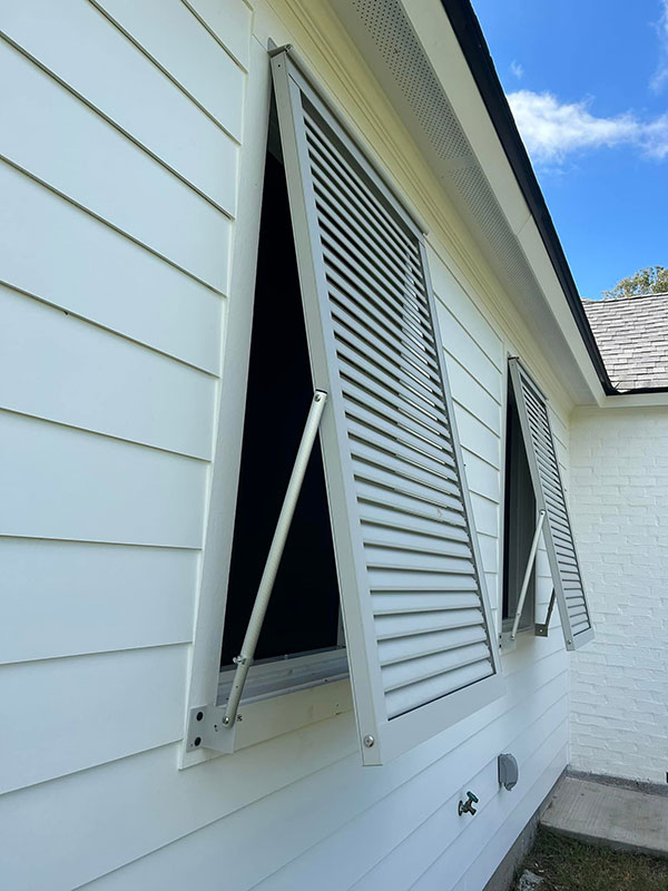 Exterior storm shutters installed for weather protection on a residential home in Lafayette, Louisiana